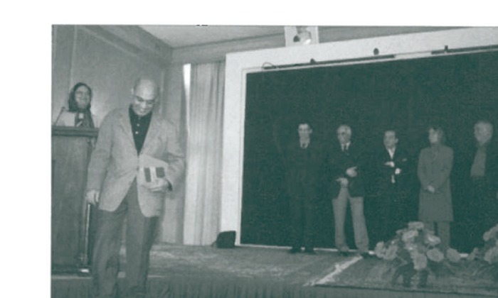 Farzad Rouzbeh receiving 4th place award
